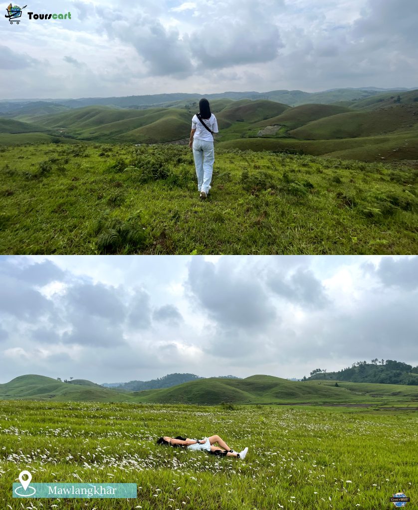 A traveler walking across the lush green rolling hills of Mawlangkhar, an offbeat destination in Meghalaya.